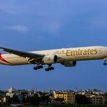 a large jetliner flying through a blue sky