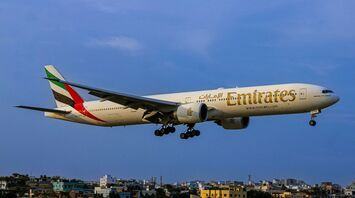 a large jetliner flying through a blue sky