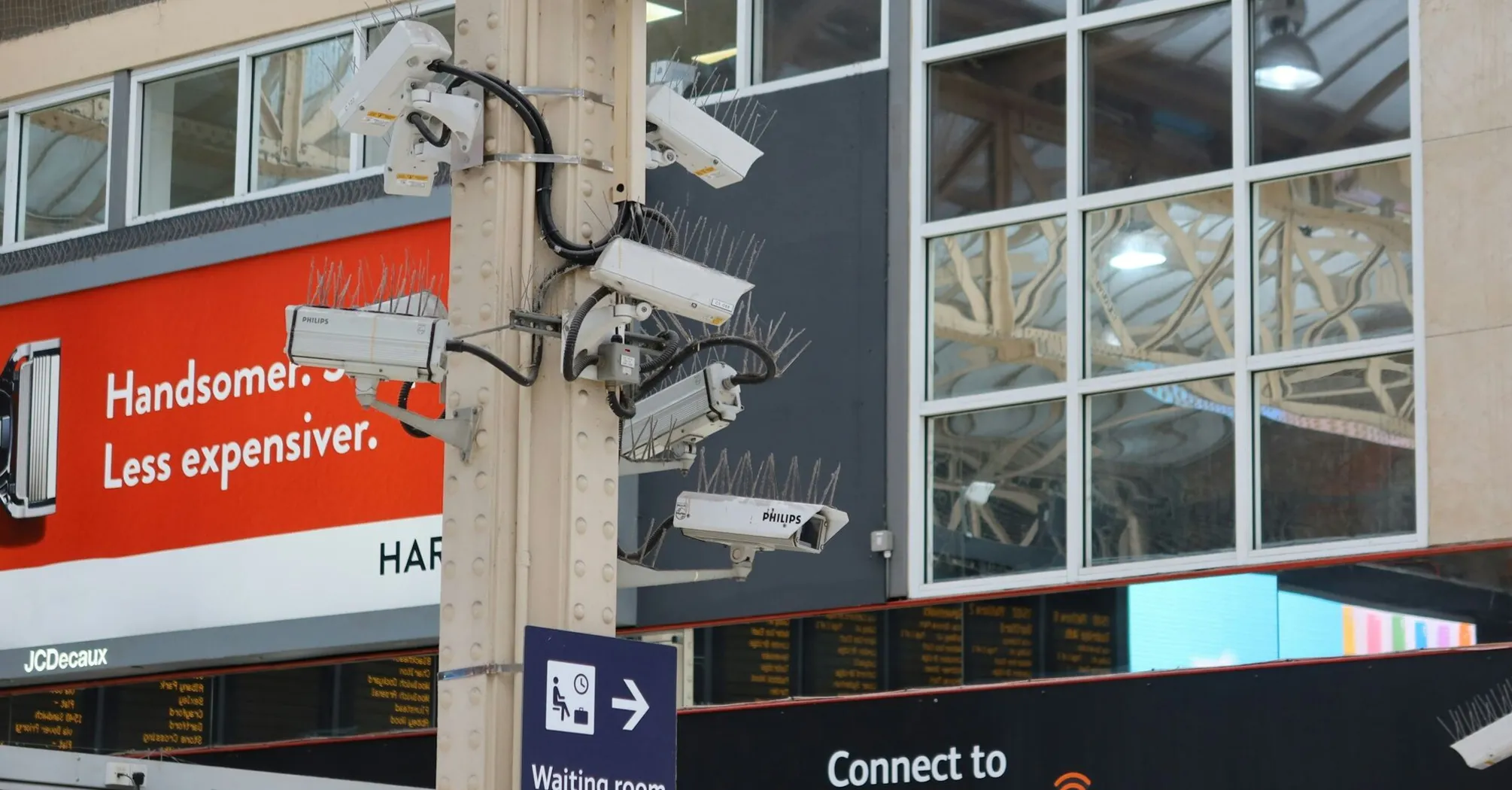 Multiple CCTV cameras mounted on a pole in a public area