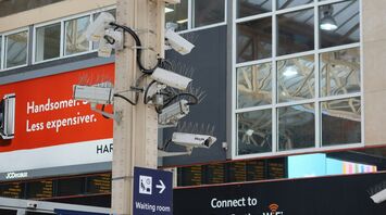 Multiple CCTV cameras mounted on a pole in a public area