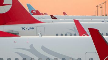 Close-up view of multiple Turkish Airlines planes parked at an airport