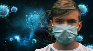 Person wearing a face mask with virus illustrations in the background