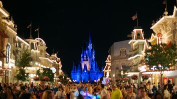 Nighttime view of Main Street in Magic Kingdom with Cinderella Castle illuminated in the background