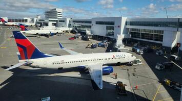 Seattle-Tacoma Airport with Delta Airlines planes on the tarmac under a blue sky before travel begins