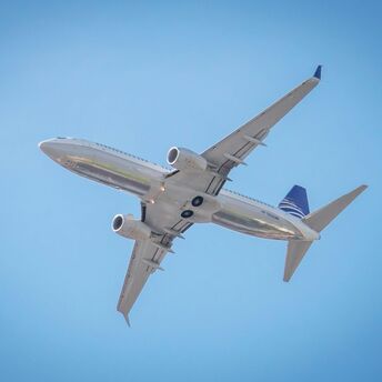 a large passenger jet flying through a blue sky