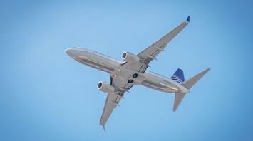 a large passenger jet flying through a blue sky