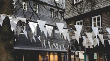 White and silver flags hanging in front of a building