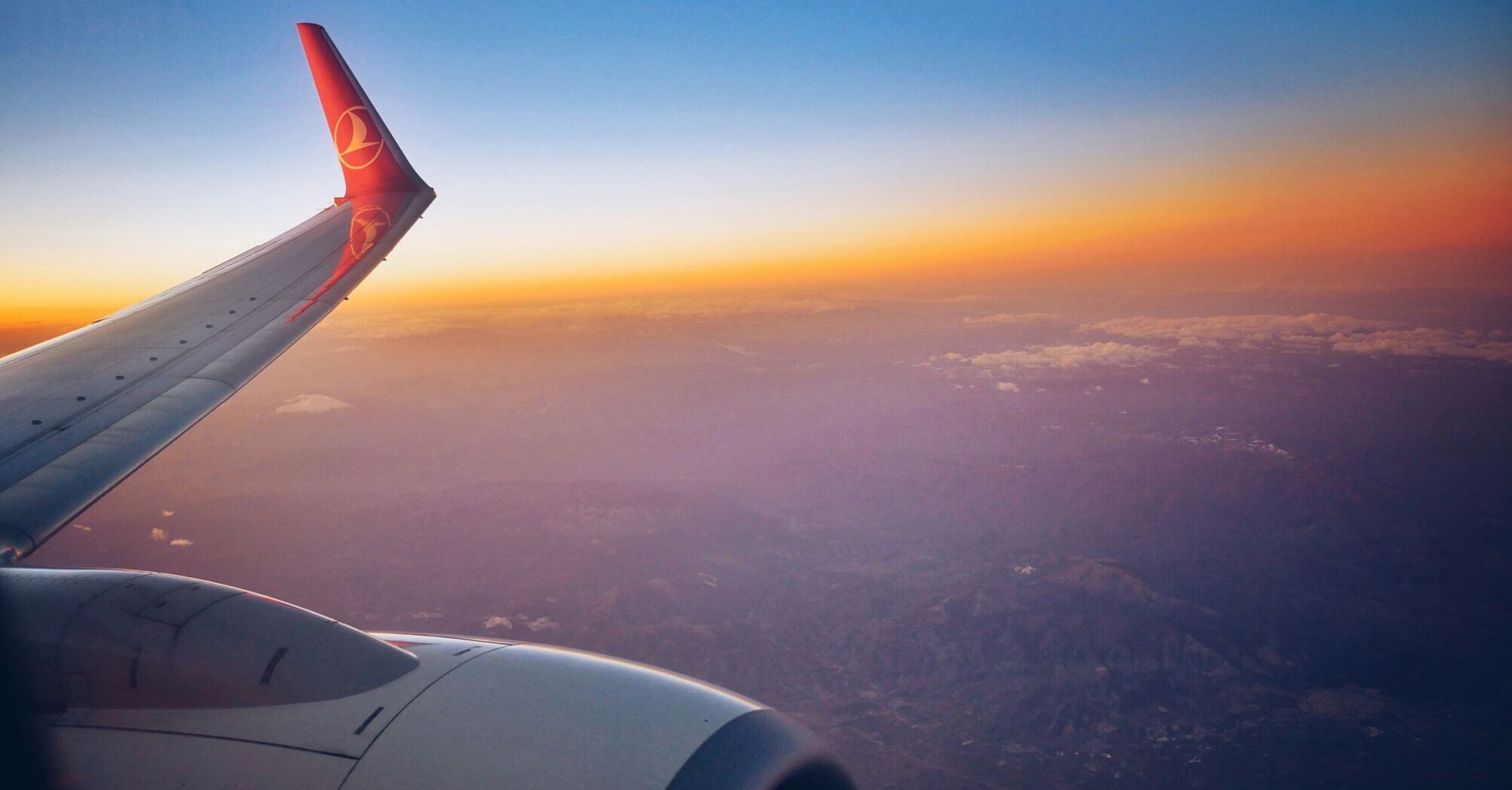 photograph of white and red airplane wing