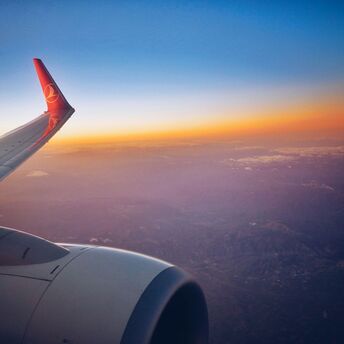 photograph of white and red airplane wing
