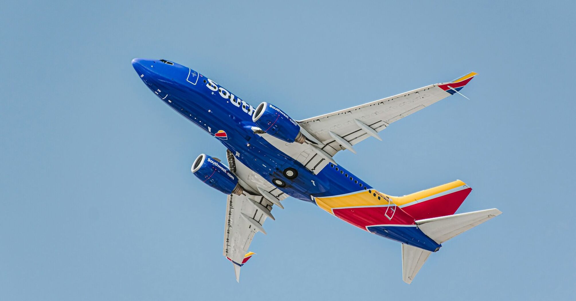 Southwest Airlines airplane flying against a blue sky