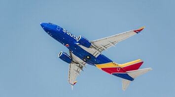 Southwest Airlines airplane flying against a blue sky