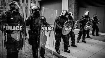 Police officers in riot gear standing in formation