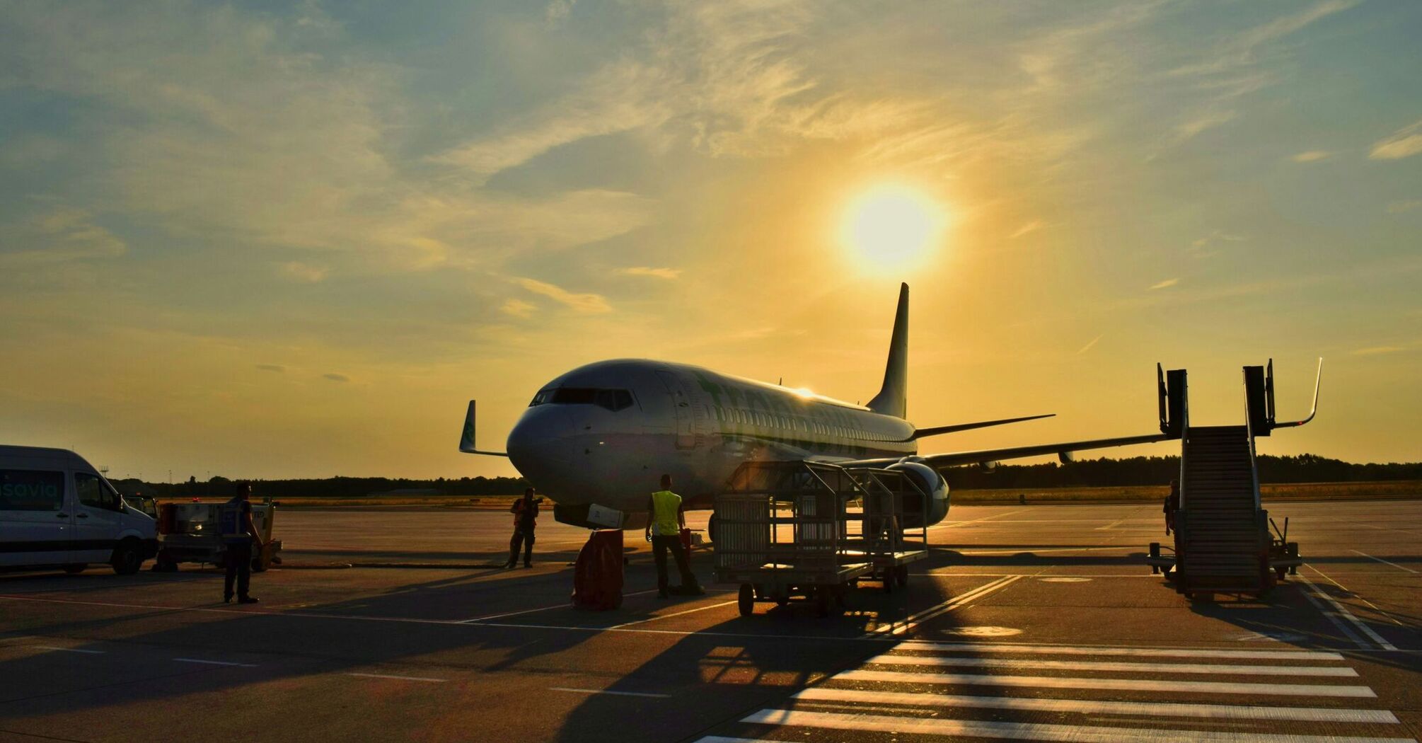 white airplane parked during daytime