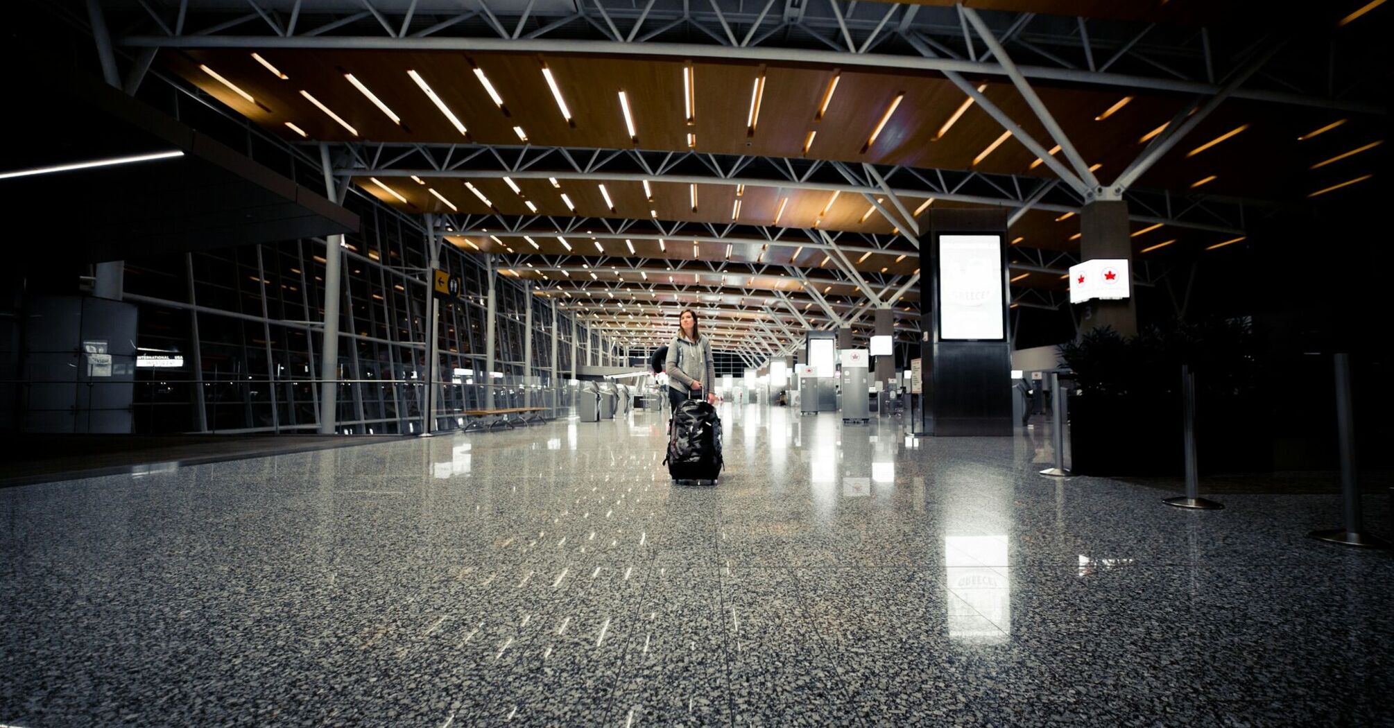 Passenger in an empty Calgary International Airport terminal