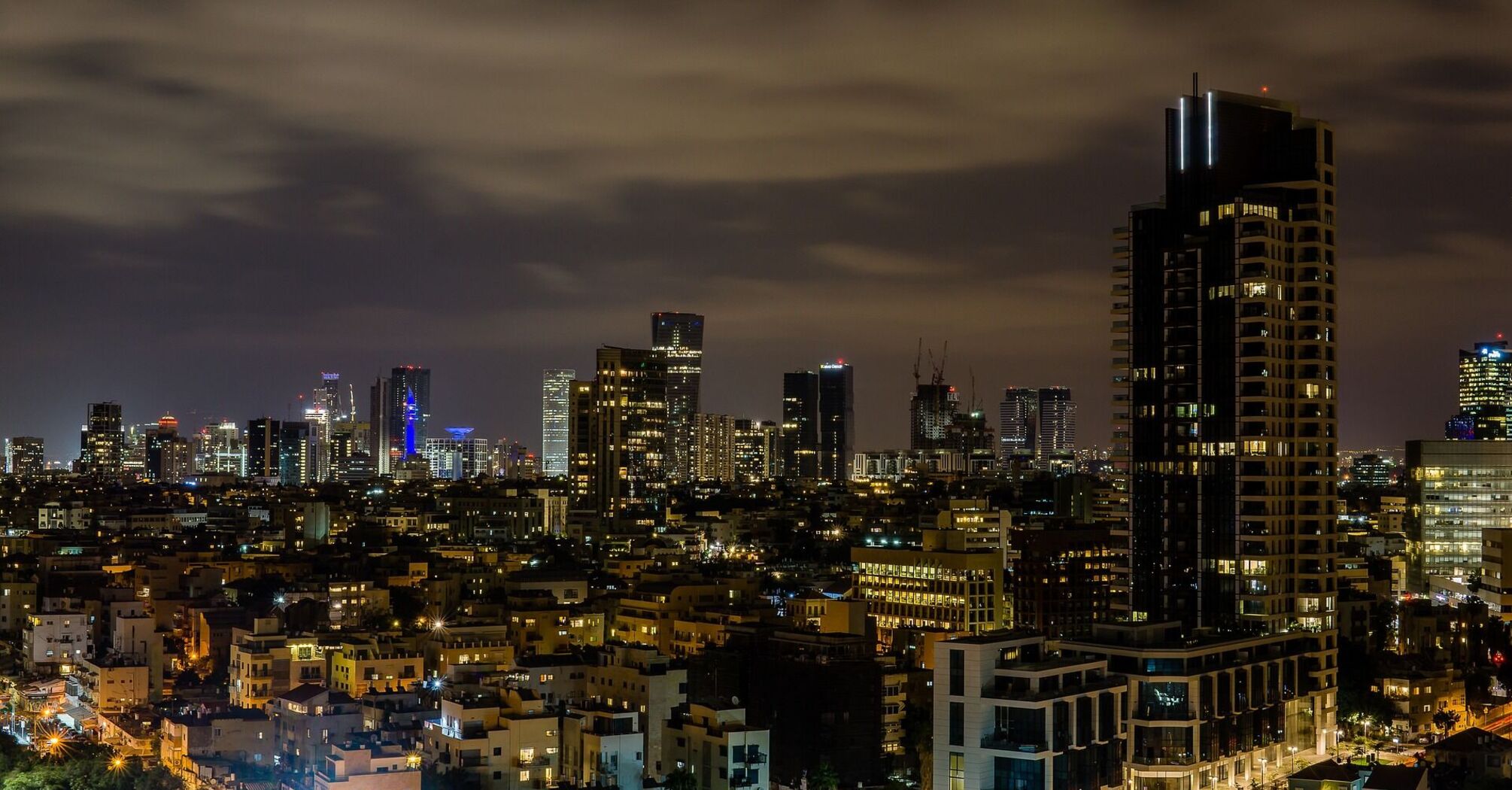 Tel Aviv skyline at night with illuminated buildings