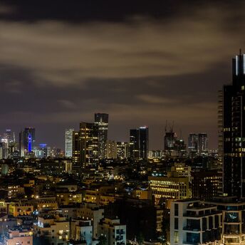 Tel Aviv skyline at night with illuminated buildings