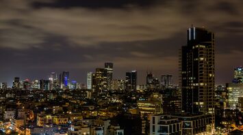 Tel Aviv skyline at night with illuminated buildings