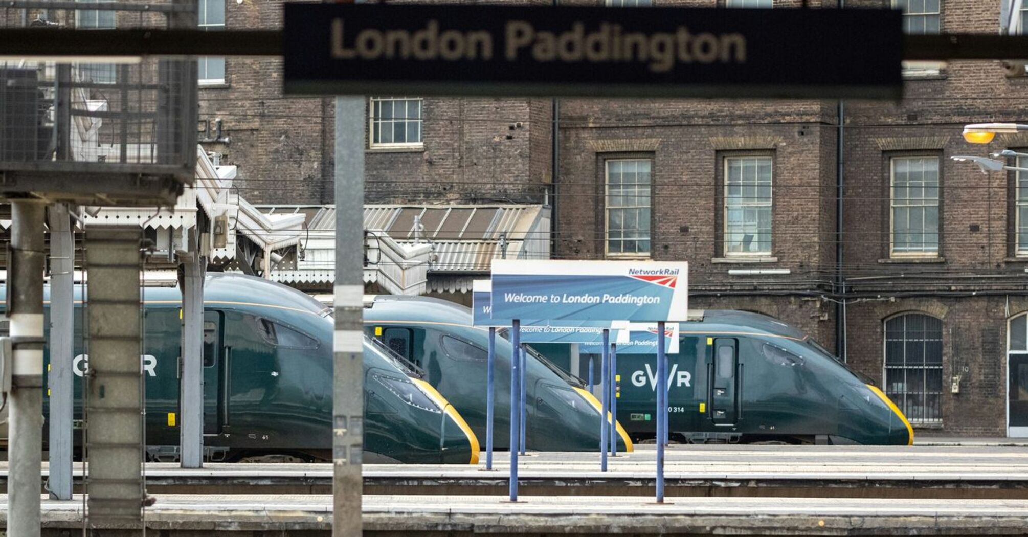 Empty train platform at London Paddington station with GWR trains in the background