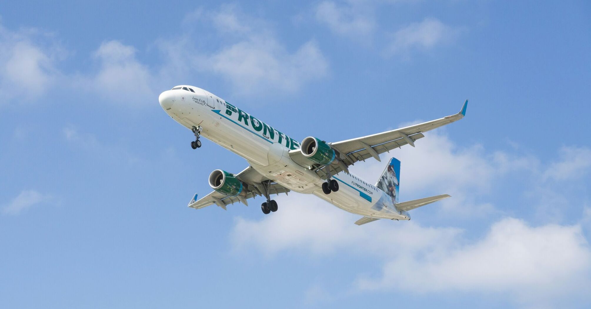 a large jetliner flying through a blue sky