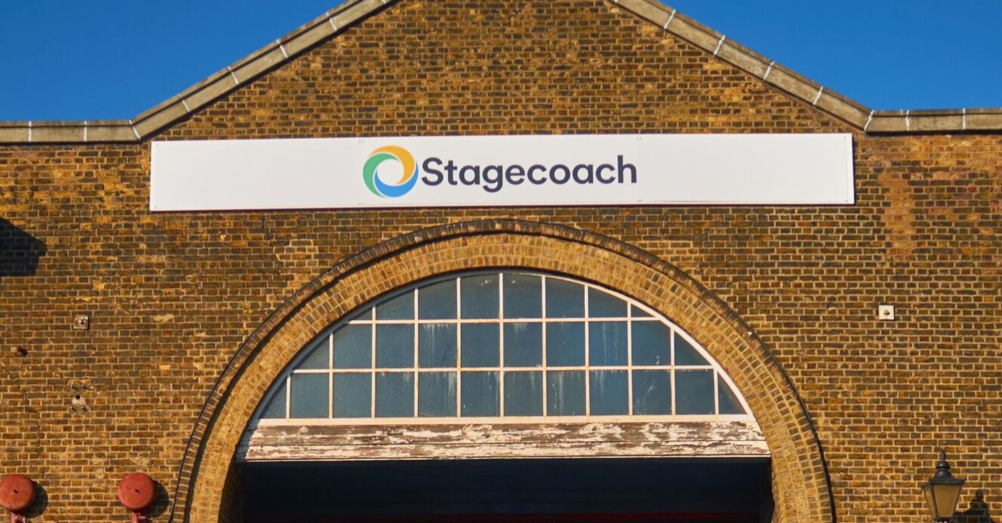 Stagecoach bus depot with bicycles and red buses in the background