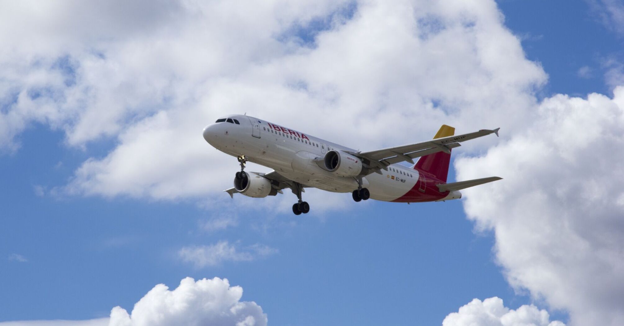 Iberia airplane flying against a backdrop of clouds