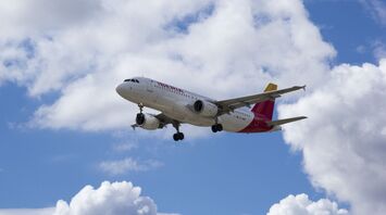 Iberia airplane flying against a backdrop of clouds