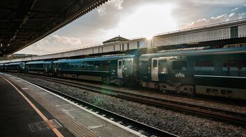 A Great Western Railway (GWR) train at a station platform during sunset in Bristol