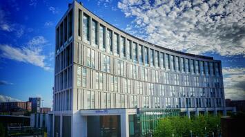 Modern Hilton hotel building against a blue sky background