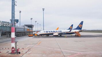 white, yellow and blue ryanar airliner on airport