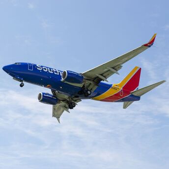 a southwest airlines plane flying in the sky
