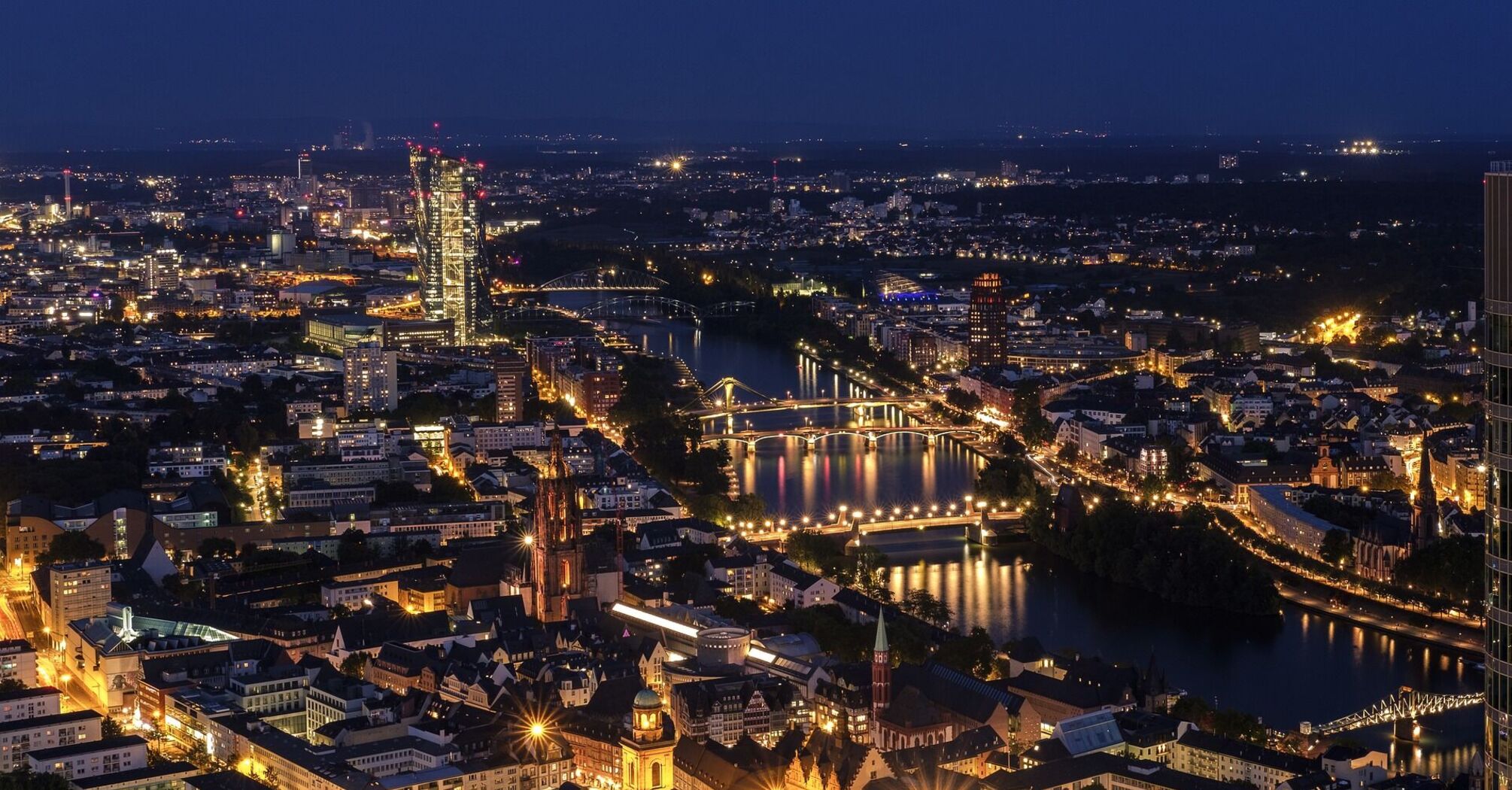 Night view of Frankfurt city skyline with illuminated bridges and buildings