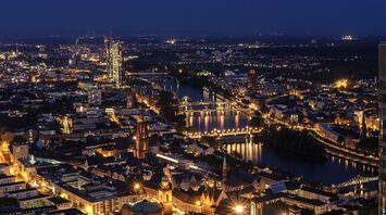 Night view of Frankfurt city skyline with illuminated bridges and buildings