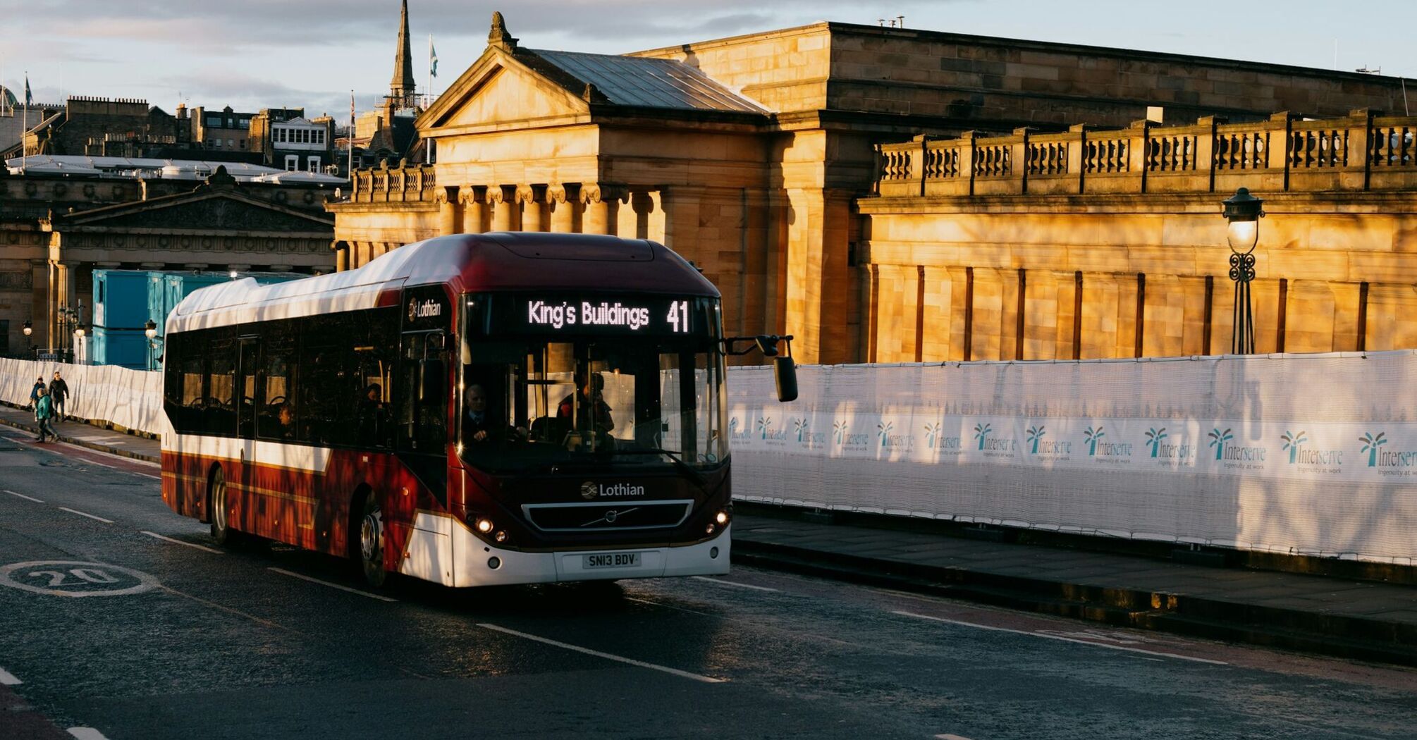 A Lothian bus labeled "King's Buildings" travels down a street in Edinburgh