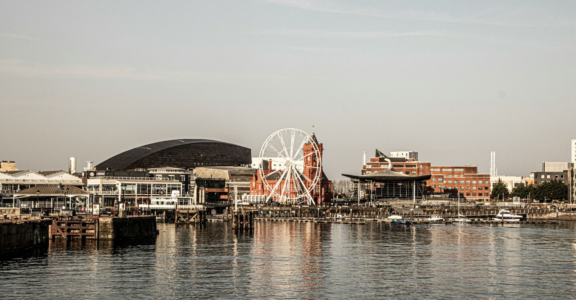 View of Cardiff waterfront featuring notable landmarks, including a Ferris wheel and modern buildings