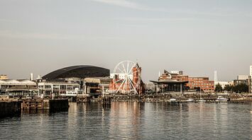 View of Cardiff waterfront featuring notable landmarks, including a Ferris wheel and modern buildings
