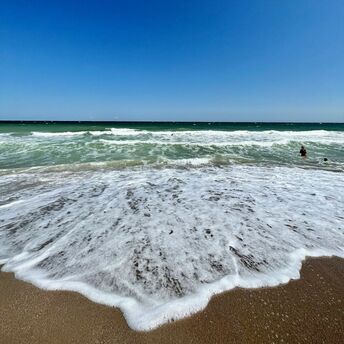 Waves washing over the sandy shore at Vama Veche, Romania