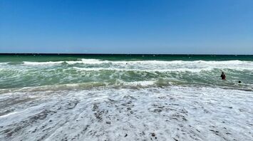 Waves washing over the sandy shore at Vama Veche, Romania
