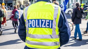 German police officer monitoring a street