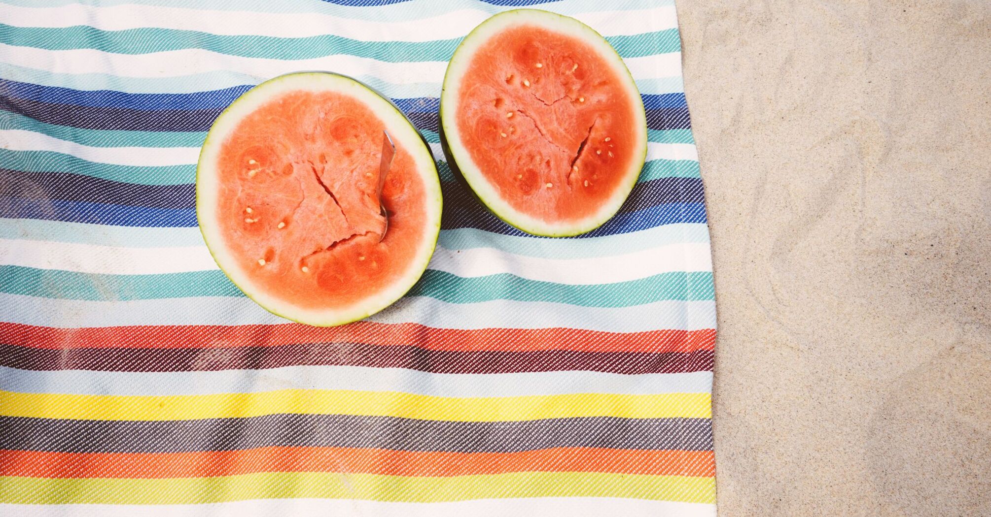 closeup photo of slice watermelon fruits on cloth