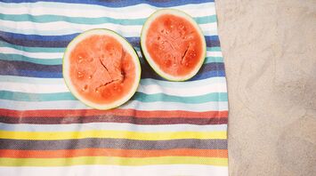 closeup photo of slice watermelon fruits on cloth