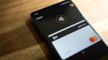A smartphone displaying a digital wallet app with a debit card