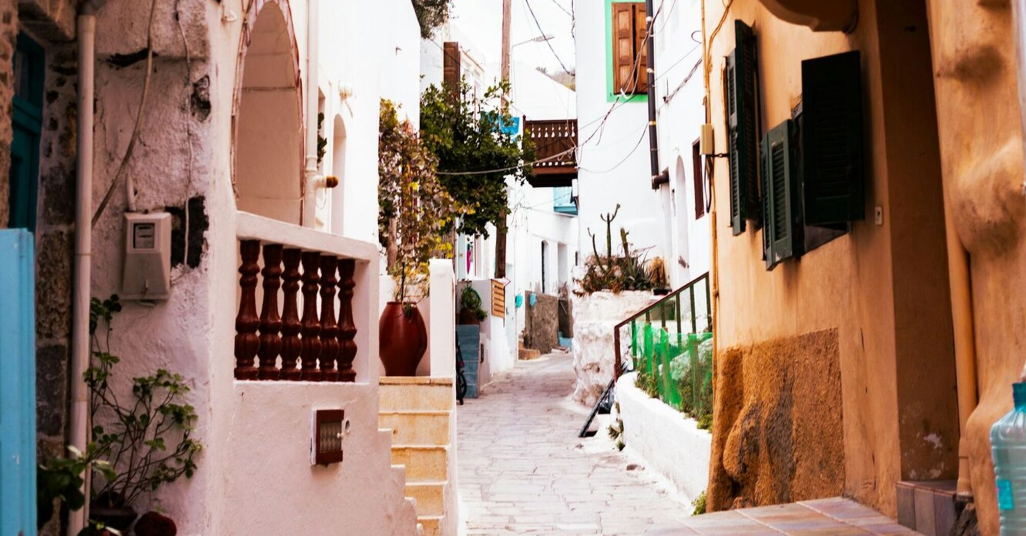 Narrow street with colorful balconies in a Greek village