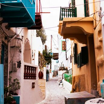 Narrow street with colorful balconies in a Greek village