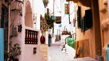 Narrow street with colorful balconies in a Greek village