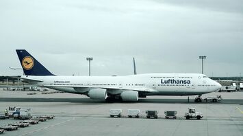 Lufthansa aircraft parked at the airport gate, preparing for a flight