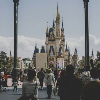 People walking toward a castle in Tokyo Disneyland