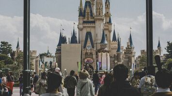 People walking toward a castle in Tokyo Disneyland