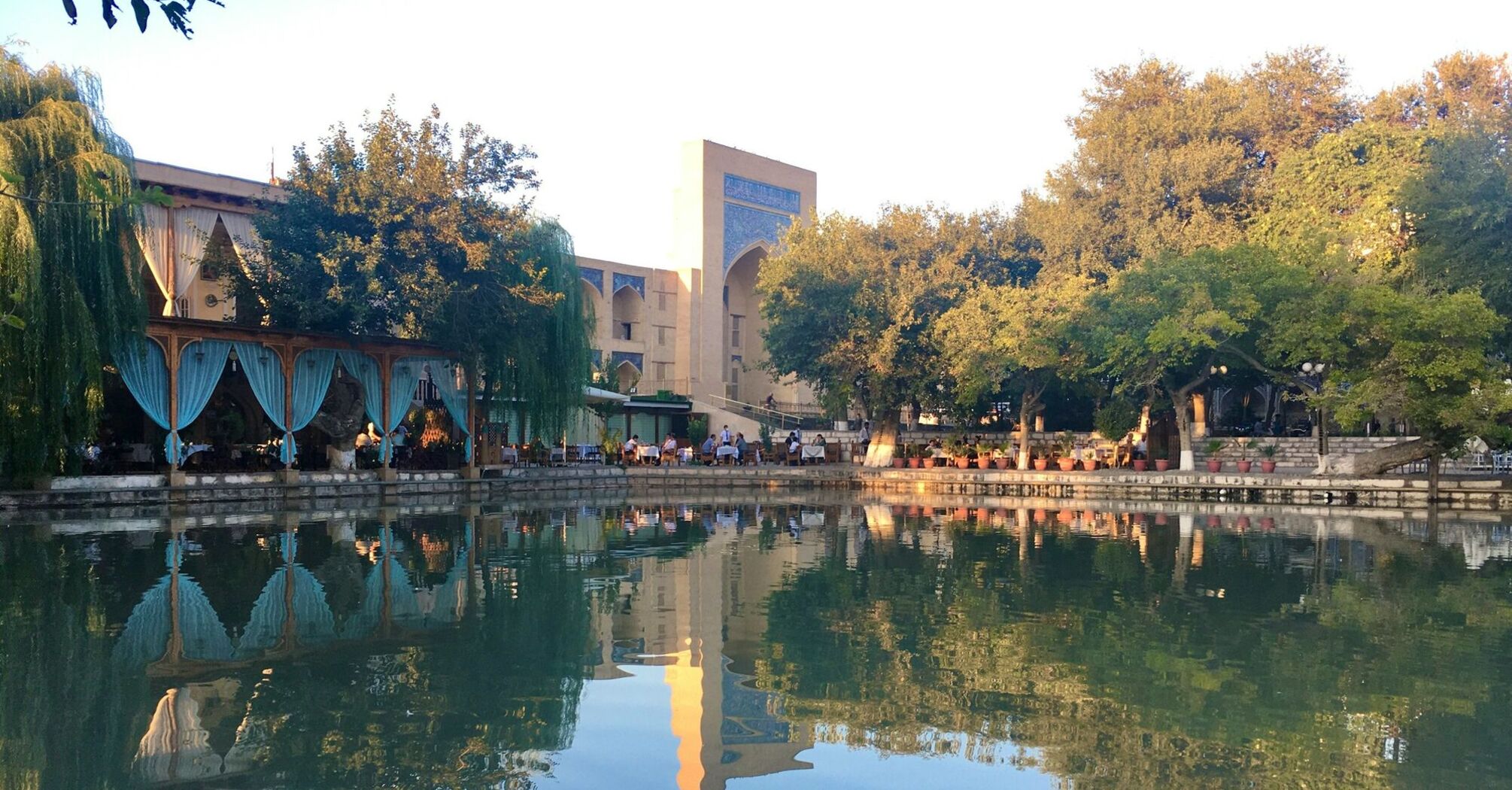 Lyab-i Hauz pond and surrounding trees in Bukhara, Uzbekistan