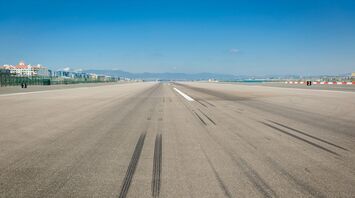 wheel marks on gray concrete pavement during daytime