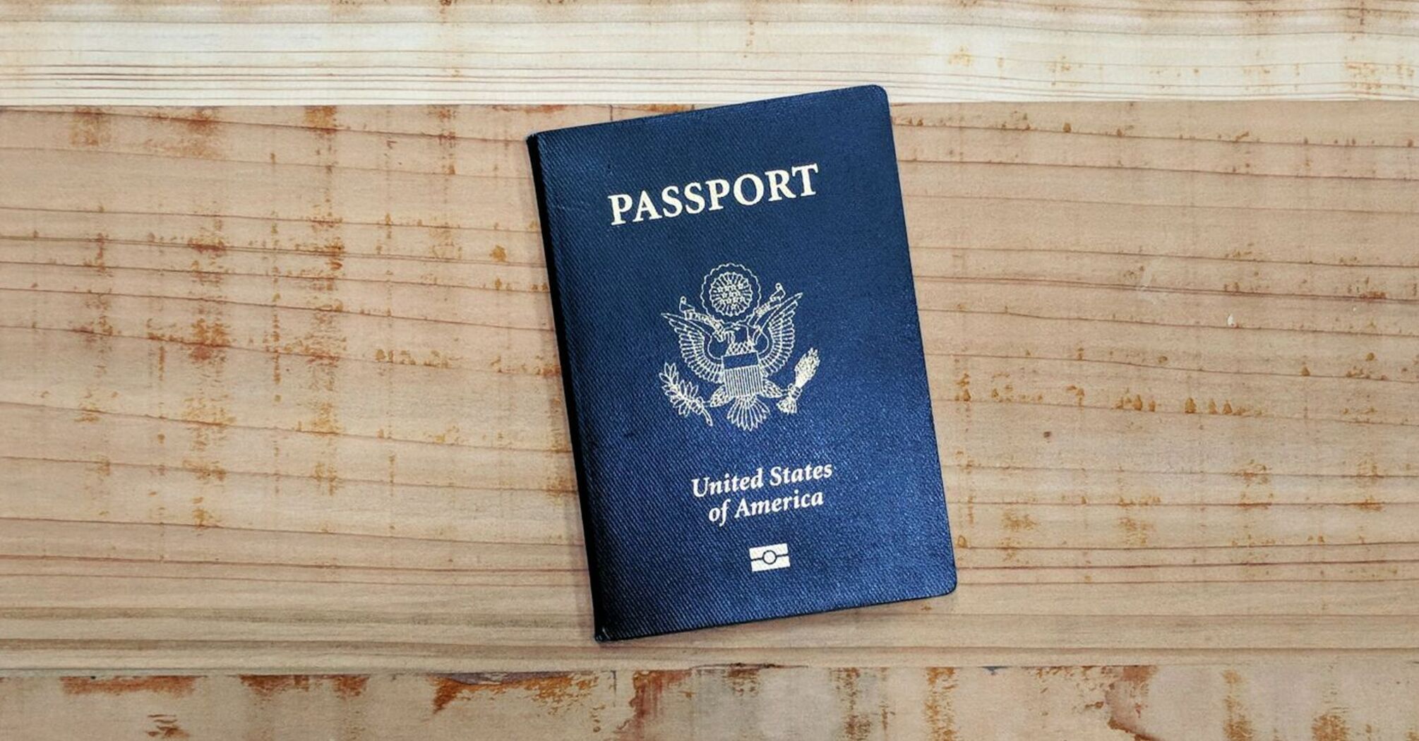 U.S. passport lying on a wooden surface